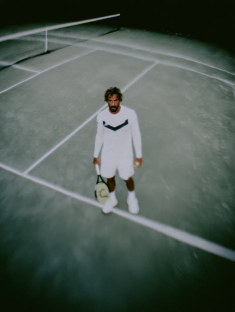 Tennis player alone on a floodlit court