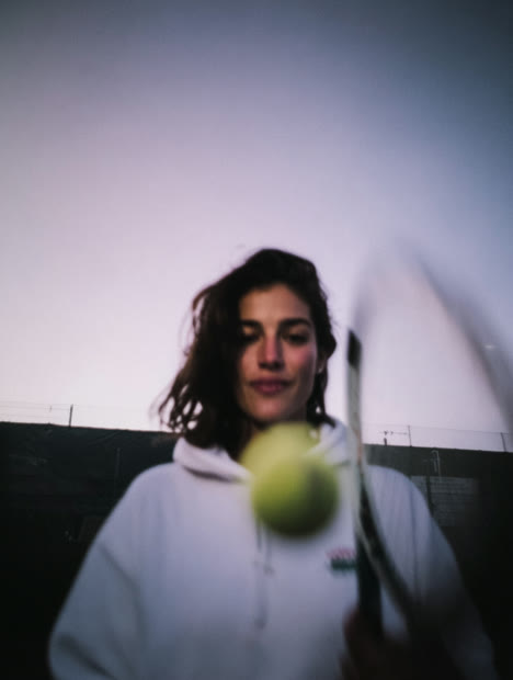 Close portrait of a tennis player with a ball mid-air