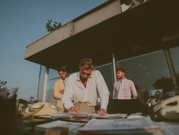 Colleagues gathered around an outdoor table at dusk